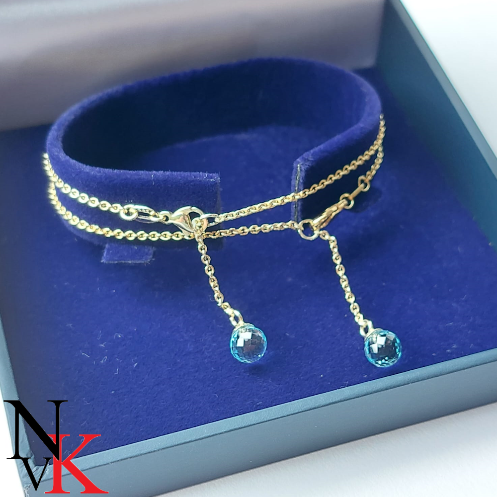 NvK Goudsmederij Geelgouden armbandjes met blauwe topazen aan de verlengstukken